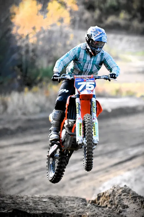 Blake Sherman riding a 2018 KTM 350SXF mid-jump at NHMX in New Hampshire